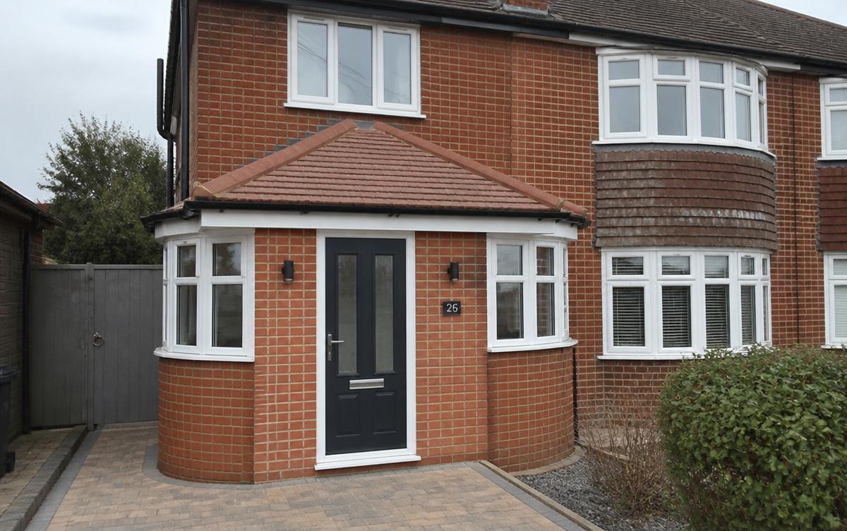 Brick-built porch with tiled pitched roof and composite front door added to a semi-detached house in Essex