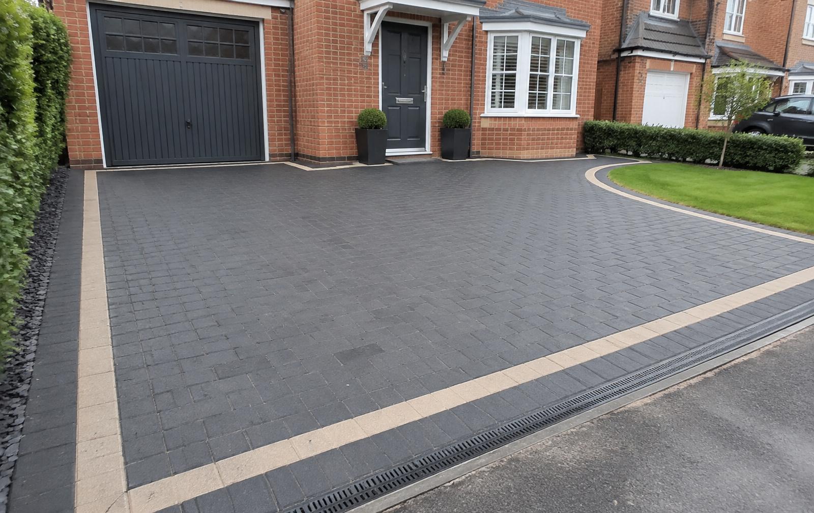 New charcoal block paving driveway with contrasting border laid in Colchester, Essex